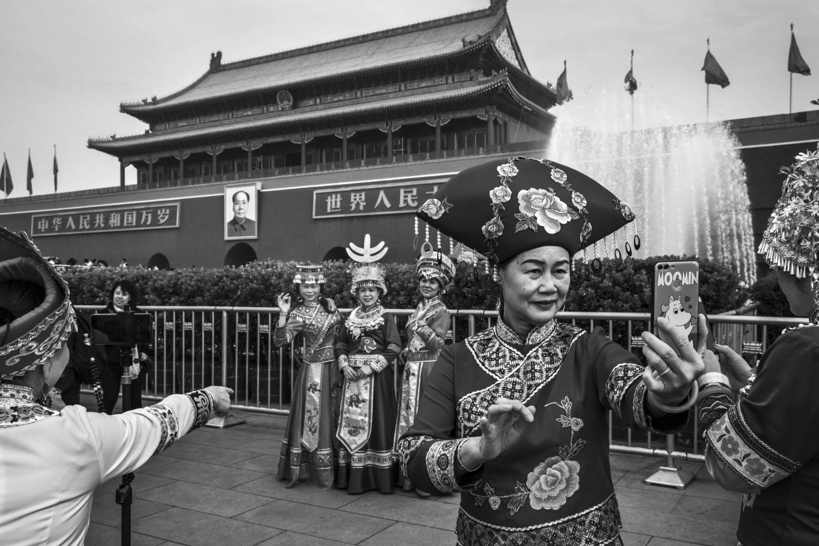 Mulheres com roupas típicas em frente à entrada da Cidade Proibida, no centro de Pequim